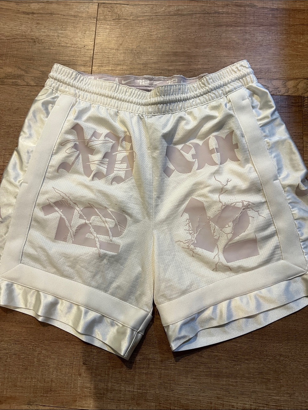 Nike Men’s White Athletic Shorts with Pale Pink Graphic